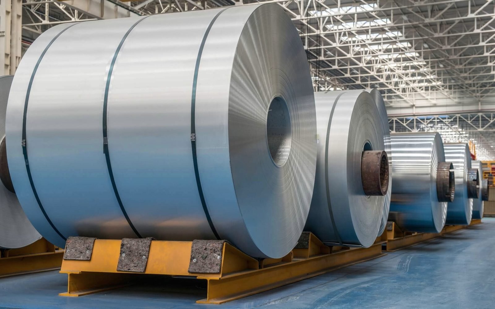 Steel coils moving on a transfer rail inside a mill